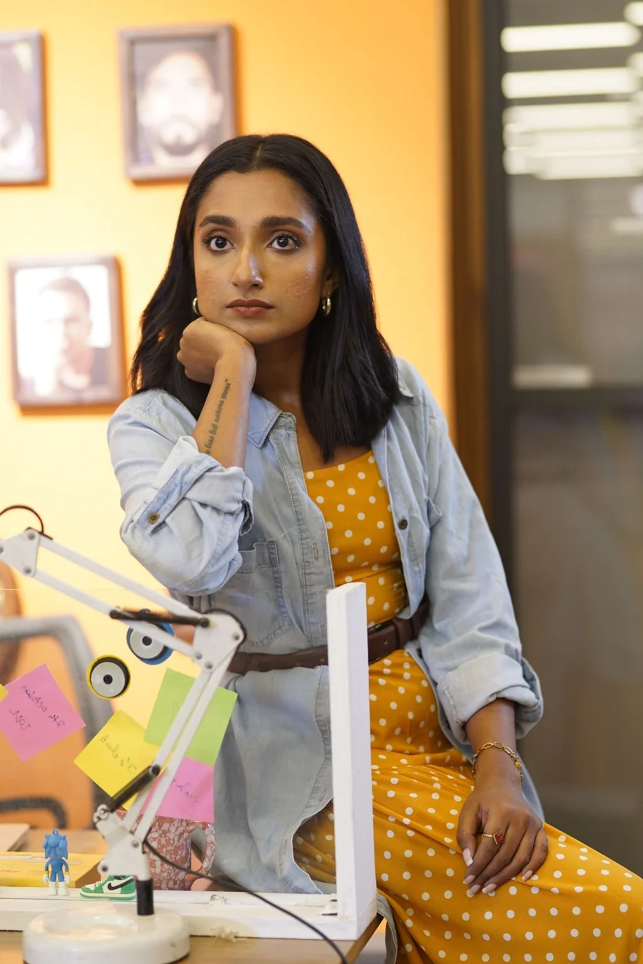 An Indian woman seated at her office desk