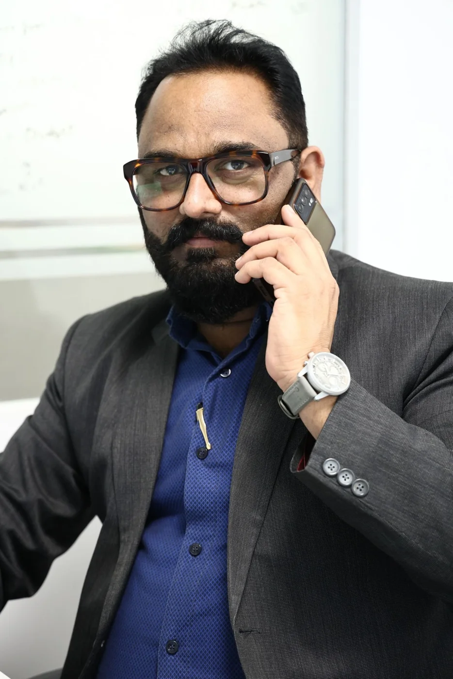 An Indian business professional speaking on the phone in Delhi