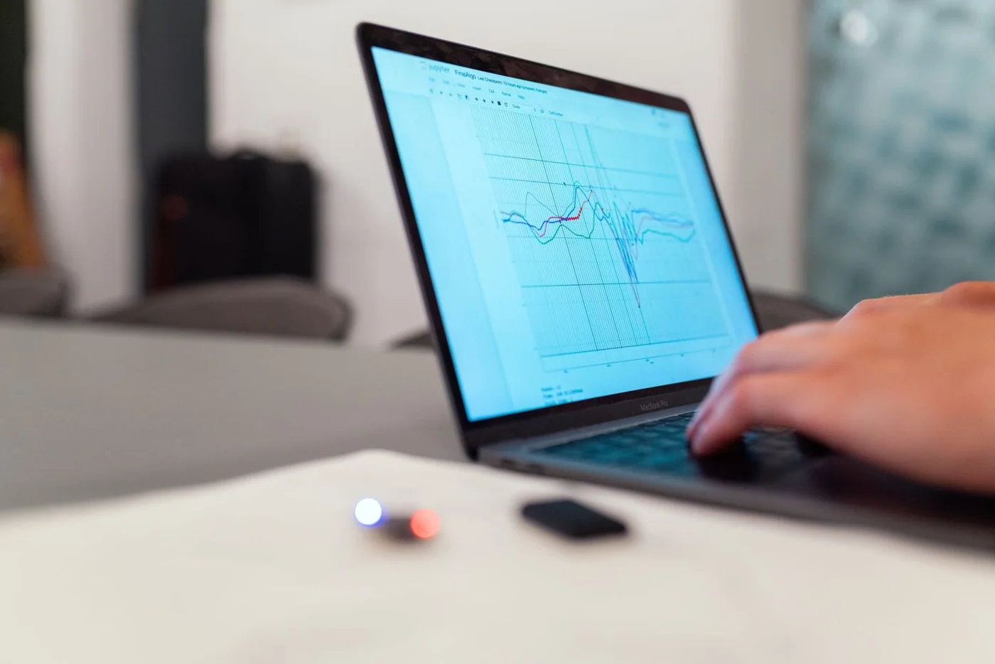 A person reviewing a graph on a laptop