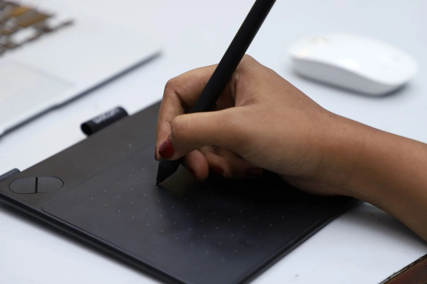 A designer using a stylus and graphics tablet in Chennai